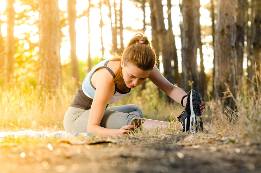 woman stretching in forest