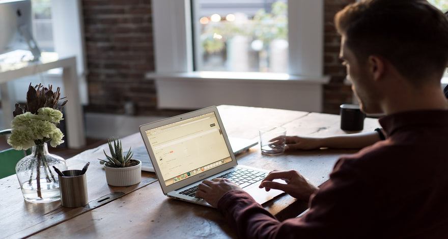 man at desk using laptop